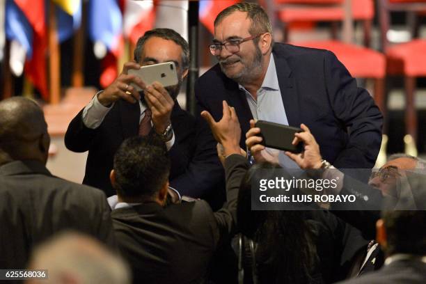Attendants take snapshots and selfies with the head of the FARC guerrilla Timoleon Jimenez, aka Timochenko after the signing of the historic peace...