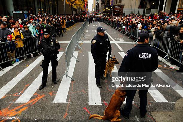 Officers stand guard as people watch the 90th Macy's Annual Thanksgiving Day Parade on November 24, 2016 in New York City. Security was tight in New...