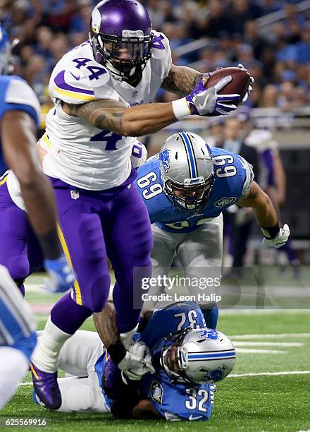 Matt Asiata of the Minnesota Vikings reaches over the goal line for a touchdown during first quarter action against the Detroit Lions at Ford Field...