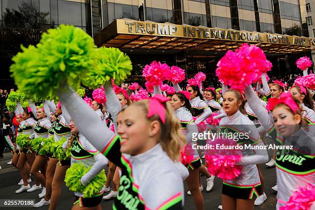 Revellers pass by Trump International Hotel as they take part during the 90th Macy's Annual Thanksgiving Day Parade on November 24, 2016 in New York...