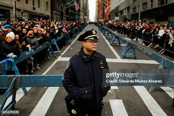 Officer stands guard as people watch the 90th Macy's Annual Thanksgiving Day Parade on November 24, 2016 in New York City. Security was tight in New...