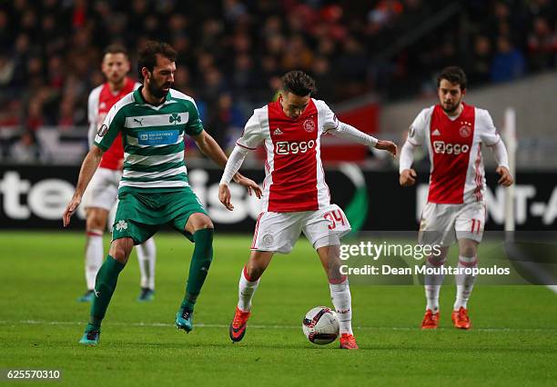 Abdelhak Nouri of Ajax evades Giorgios Koutroubis of Panathinaikos during the UEFA Europa League Group G match between AFC Ajax and Panathinaikos FC...