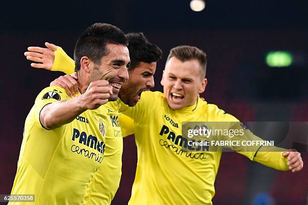 Villarreal's Spanish midfielder Bruno Soriano celebrates after a goal with teammates Argentinian defender Mateo Musacchio and Russian midfielder...