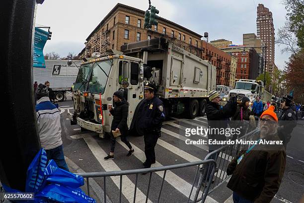 Officers stand guard next to trucks blocking the access to the parade as people arrive to watch the 90th Macy's Annual Thanksgiving Day Parade on...