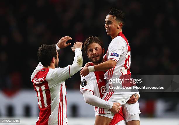 Lasse Schone of Ajax celebrates with Amin Younes and Abdelhak Nouri as he scores their first goal during the UEFA Europa League Group G match between...