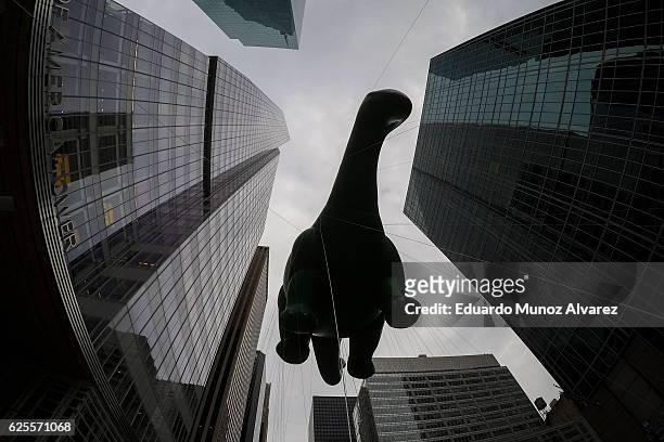 The Dino balloon floats down 6th Av, during the 90th Macy's Annual Thanksgiving Day Parade on November 24, 2016 in New York City. Security was tight...