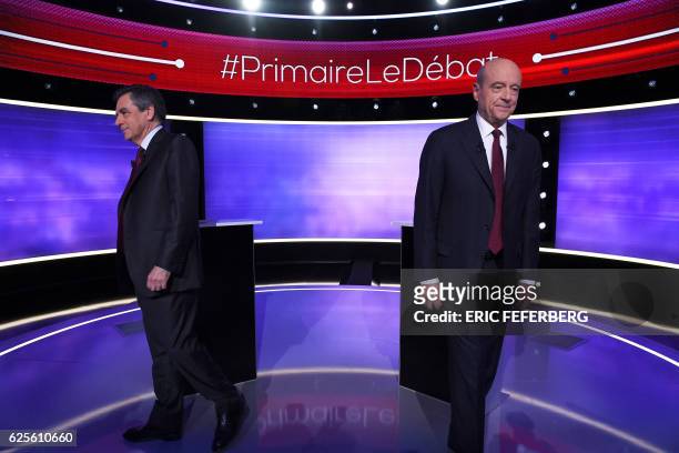 The two finalists in France's conservative presidential primary, Francois Fillon and Alain Juppe, leave after posing for photographs prior to taking...