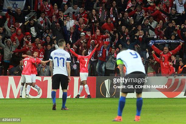 Hapoel's players celebrate with their fans after winning the UEFA Europa League group K football match between Israel's Hapoel Beer Sheva and Italy's...