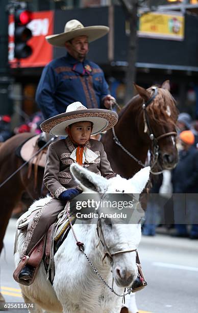 People attend the 83rd Annual Thanksgiving Day Parade at State Street in Chicago, Illinois on November 24, 2016. The parade featured marching bands...