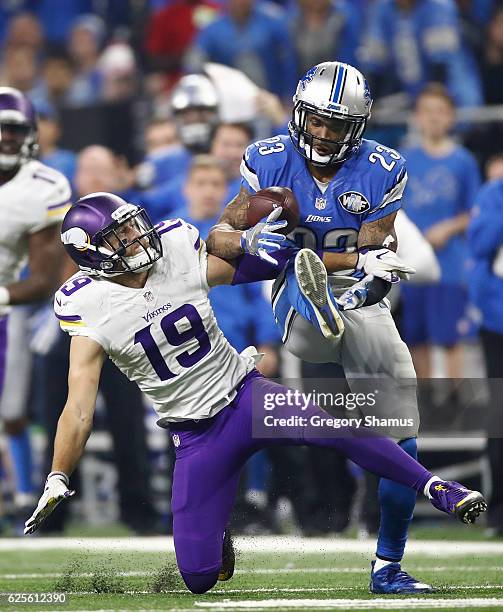Darius Slay of the Detroit Lions intercepts a pass in front of Adam Thielen of the Minnesota Vikings with 30 seconds left in the fourth quarter at...