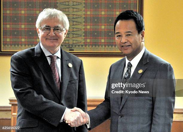 Brunei - Akira Amari , the Japanese minister in charge of Trans-Pacific Partnership free trade negotiations, shakes hands with New Zealand Trade...