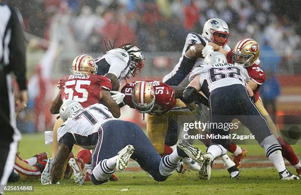 Ahmad Brooks and Gerald Hodges of the San Francisco 49ers tackle LeGarrette Blount of the New England Patriots during the game at Levi Stadium on...