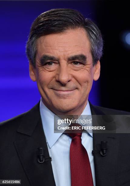 One of the two finalists in France's conservative presidential primary, Francois Fillon, smiles prior to taking part in the first televised debate...