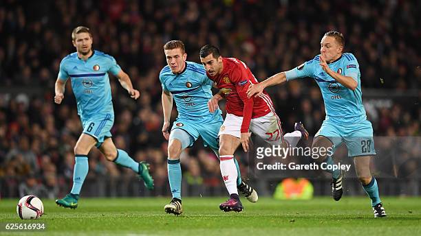 Henrikh Mkhitaryan of Manchester United goes between Jens Toornstra and Wessel Dammers of Feyenoord during the UEFA Europa League Group A match...
