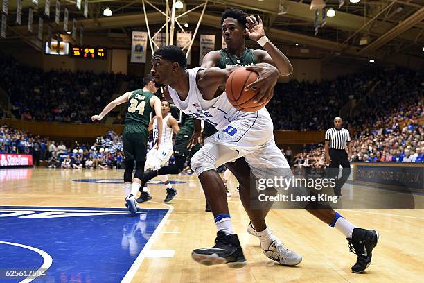 Amile Jefferson of the Duke Blue Devils drives against Nathan Knight of the William & Mary Tribe during their game at Cameron Indoor Stadium on...