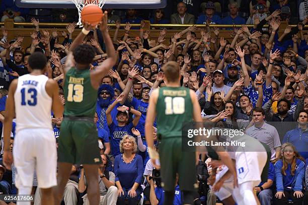 Cameron Crazies and fans of the Duke Blue Devils try to distract Nathan Knight of the William & Mary Tribe at Cameron Indoor Stadium on November 23,...