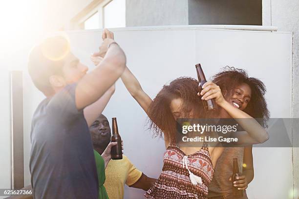 group of friends partying on rooftop - lise gagne stock pictures, royalty-free photos & images