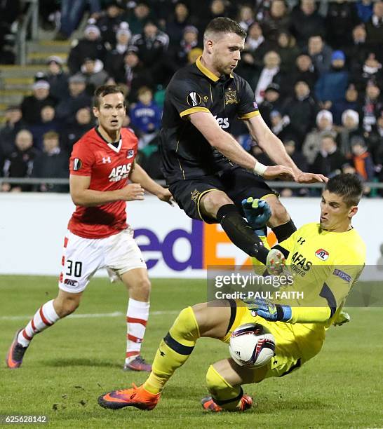 Dundalk's Irish striker Ciaran Kilduff clashes with AZ Alkmaar's Uruguayan goalkeeper Sergio Rochet during the UEFA Europa League group D football...