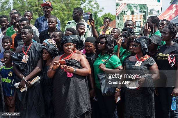 People wait outside the Manhyia Palace, residence of the Asantehene of Asanteman, prior to the official ceremony following the death of Nana Afia...