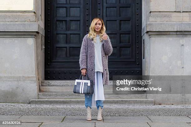 Jessi Quednau wearing light grey Buffalo boots, blue Levis denim jeans, grey poncho Zara, white blouse Zara, a grey teddy fluffy coat Lala Berlin, a...