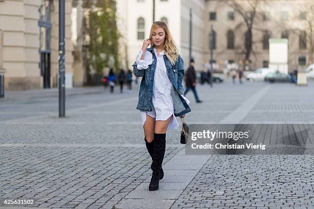 Jessi Quednau wearing black heeled overknees Asos, a white dress with long wide sleeves Storets, a blue denim jacket with print on the back Mavi, a...