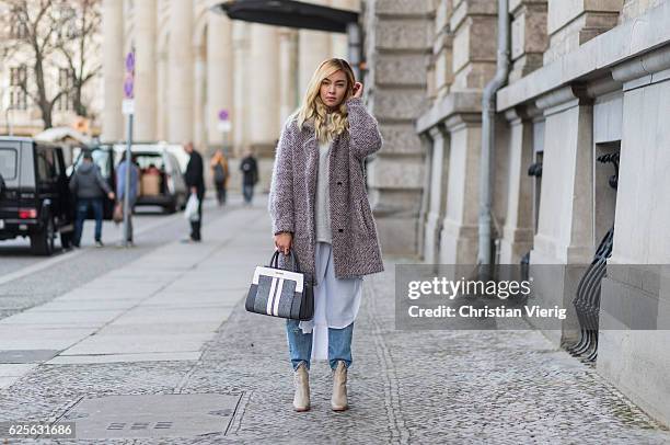 Jessi Quednau wearing light grey Buffalo boots, blue Levis denim jeans, grey poncho Zara, white blouse Zara, a grey teddy fluffy coat Lala Berlin, a...