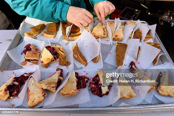 Volunteer Nancy Dickinson picks up pieces of pie as she prepares Thanksgiving day lunches at The Squeaky Bean to be delivered to the homeless, to...