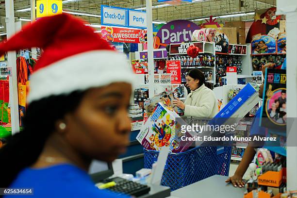 Shoppers buy gifts at the Toys"R"Us store during early Black Friday events on November 24, 2016 in Paramus, New Jersey. Although Black Friday sales...