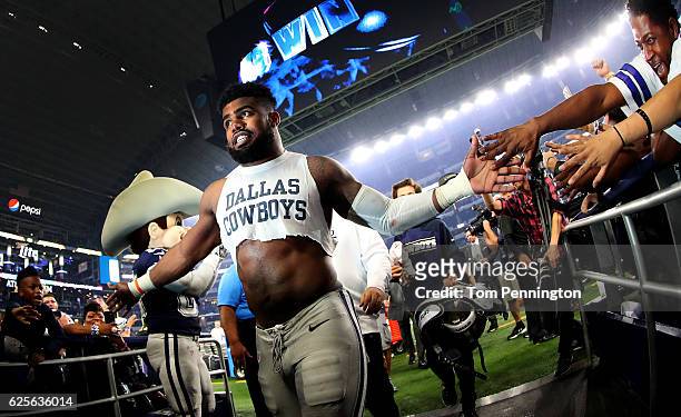 Ezekiel Elliott of the Dallas Cowboys celebrates with fans after the Dallas Cowboys beat the Washington Redskins 31-26 at AT&T Stadium on November...