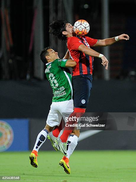 Diego Arias of Atletico Nacional struggles for the ball with Guillermo Beltran of Cerro Porteño during a second leg match between Atletico Nacional...