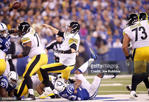 Ben Roethlisberger of the Pittsburgh Steelers passes the ball while being tackled by T.J. Green of the Indianapolis Colts during the first quarter of...