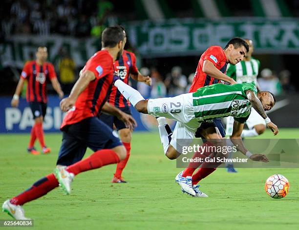 Arley Rodriguez of Atletico Nacional struggles for the ball with Marcos Caceres of Cerro Porteño during a second leg match between Atletico Nacional...