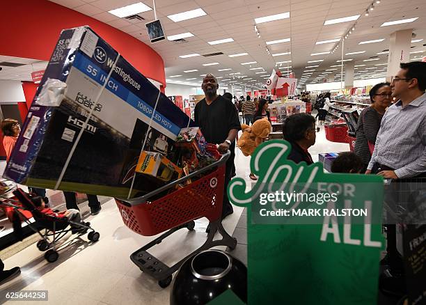 Thanksgiving Day shoppers push loaded up carts during the "Black Friday" sales at a Target store in Culver City, California on November 24, 2016. US...