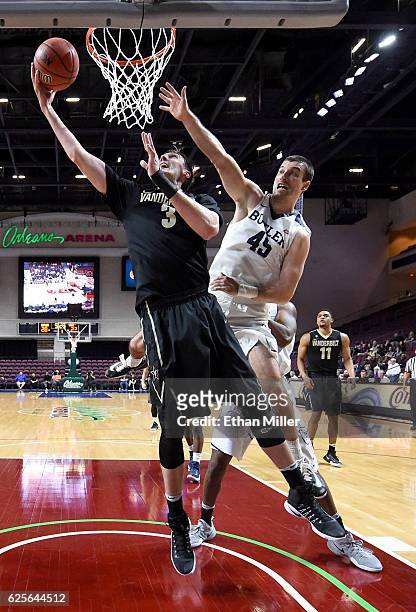 Luke Kornet of the Vanderbilt Commodores drivs to the basket against Andrew Chrabascz of the Butler Bulldogs during the 2016 Continental Tire Las...