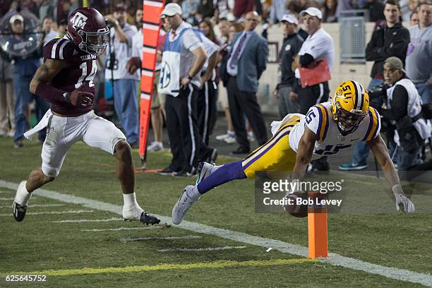 Malachi Dupre of the LSU Tigers dives for the pylon but was ruled out art the three yard line as Justin Evans of the Texas A&M Aggies pursued in the...
