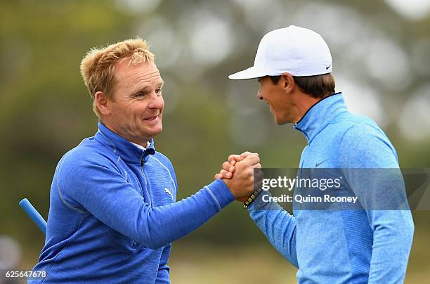 Soren Kjeldsen and Thorbjorn Olesen of Denmark shake hands after finishing on the 18th during day two of the World Cup of Golf at Kingston Heath Golf...