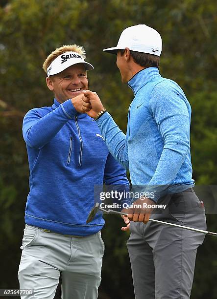 Soren Kjeldsen and Thorbjorn Olesen of Denmark celebrate a birdie during day two of the World Cup of Golf at Kingston Heath Golf Club on November 25,...