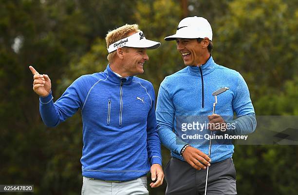 Soren Kjeldsen and Thorbjorn Olesen of Denmark celebrate a birdie during day two of the World Cup of Golf at Kingston Heath Golf Club on November 25,...