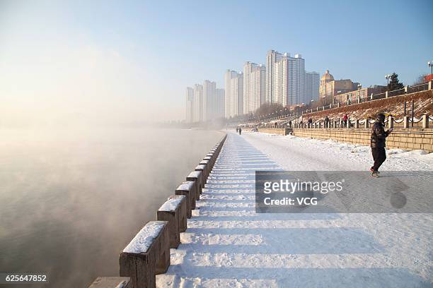 Fog rises from the water of Songhua River after a powerful cold front swept across the city on November 25, 2016 in Jilin, Jilin Province of China....