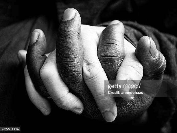 holding hands - black and white people holding hands stock pictures, royalty-free photos & images