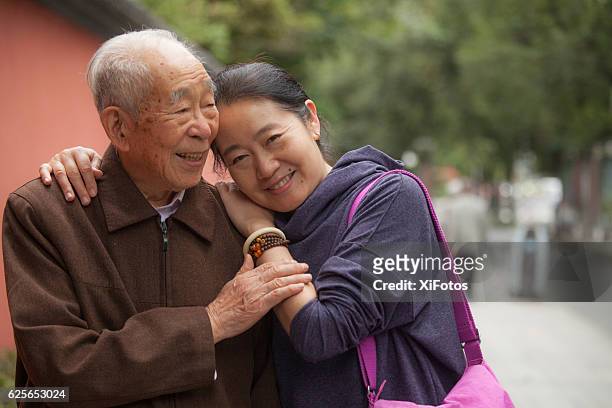 elderly father and his middle aged daughter - chinese ethnicity stock pictures, royalty-free photos & images