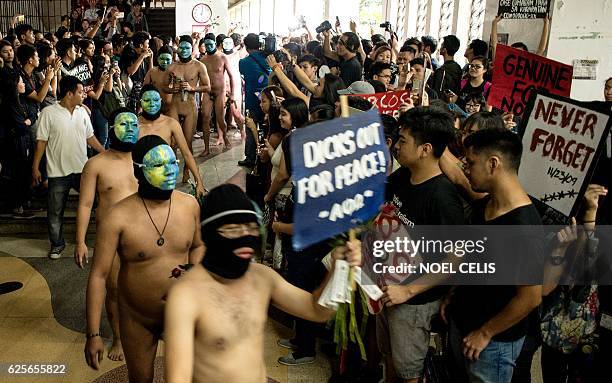 Graphic content / Nude members of a university fraternity participate in a "Oblation Run" to protest against the burial of the late dictator...