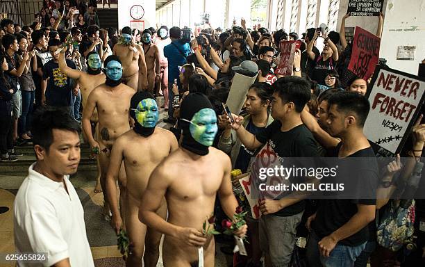 Graphic content / Nude members of a university fraternity participate in a "Oblation Run" to protest against the burial of the late dictator...