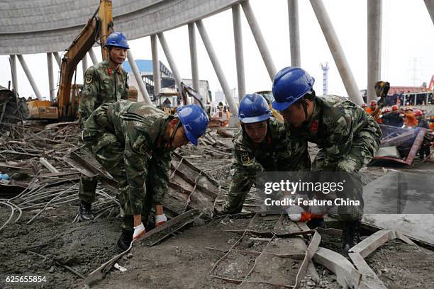 Rescuers search for victims inside a cooling tower of a coal-fired power plant under construction in Jiangxi province on November 24, 2016 in...