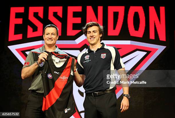 Essendon Football Club head coach John Worsfold poses for a photo with the number one draft pick Andrew Mcgrath of the Essendon Football Club during...