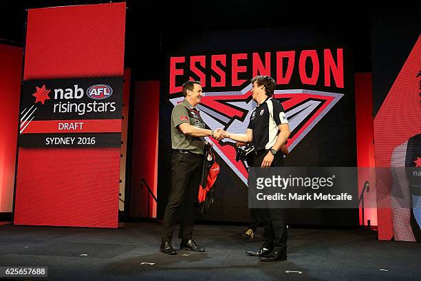 Essendon Football Club head coach John Worsfold shakes hands with the number one draft pick Andrew Mcgrath of the Essendon Football Club during the...