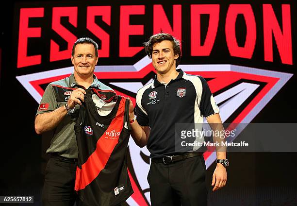 Essendon Football Club head coach John Worsfold poses for a photo with the number one draft pick Andrew Mcgrath of the Essendon Football Club during...