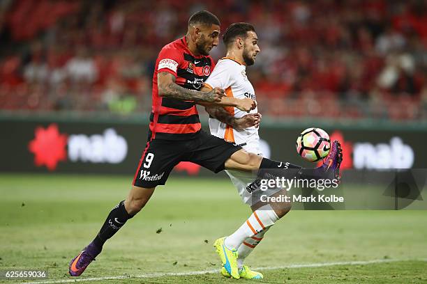 Kerem Bulut of the Wanderers misses a chance in front of goal under pressure from Brett Holman of the Roar during the round eight A-League match...