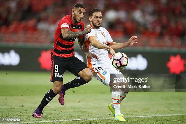 Kerem Bulut of the Wanderers misses a chance in front of goal under pressure from Brett Holman of the Roar during the round eight A-League match...