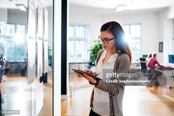 woman working in front of glass in office - future proof stock pictures, royalty-free photos & images